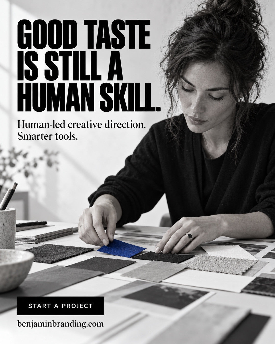 A designer arranging material and color swatches beneath Good taste is still a human skill.