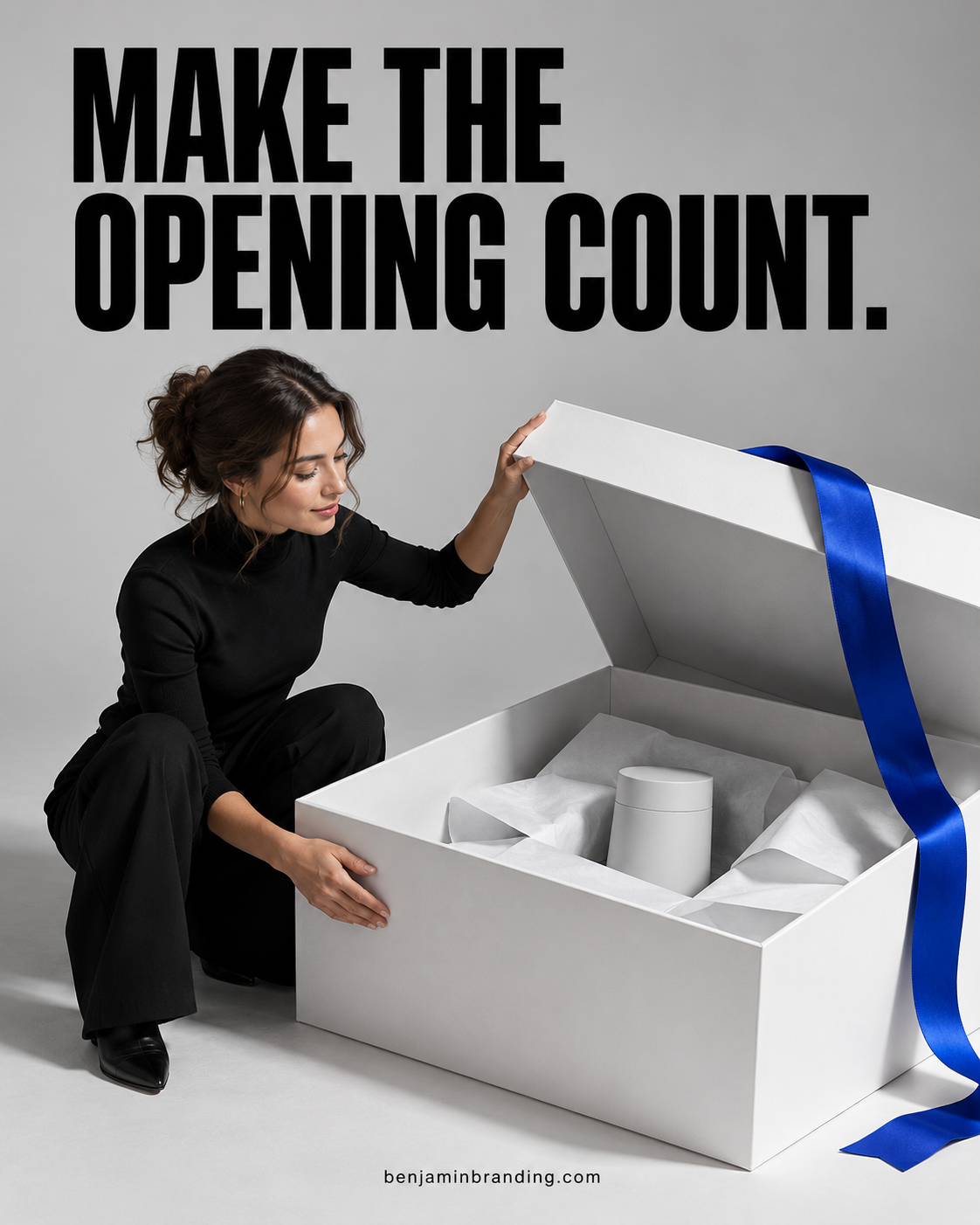 Designer opening an oversized white presentation box with a blue ribbon beneath Make the opening count.